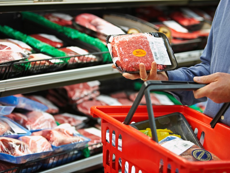 Shopper Selecting Package of Ground Beef