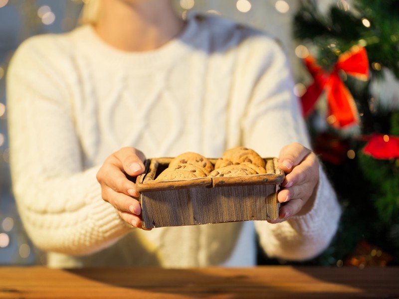 woman holding box of cookies