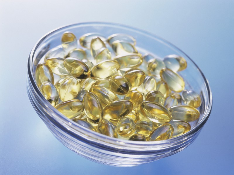 Close-up of vitamin capsules in a bowl